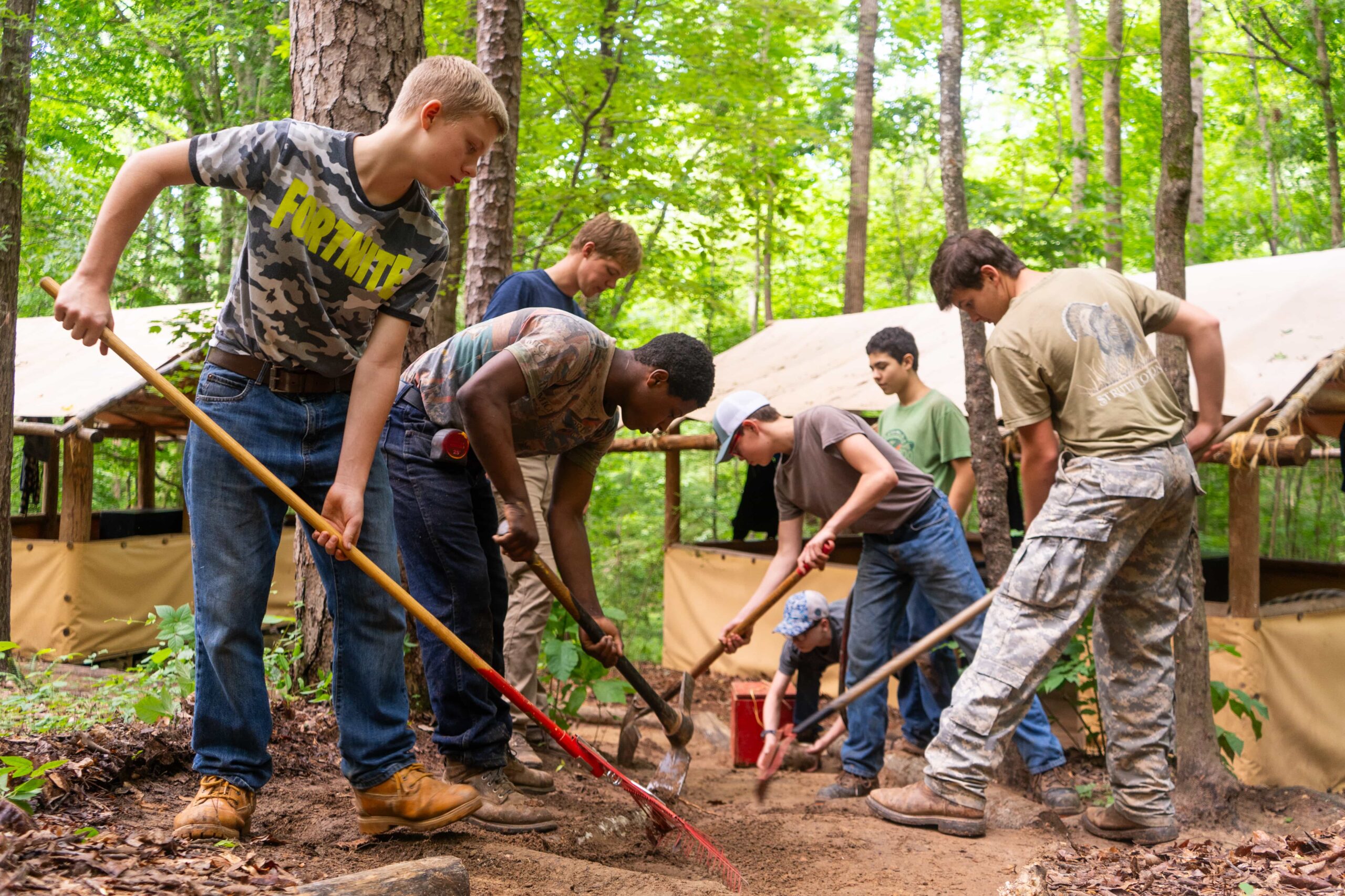 Fair Play Camp boys working together to clear a campsite