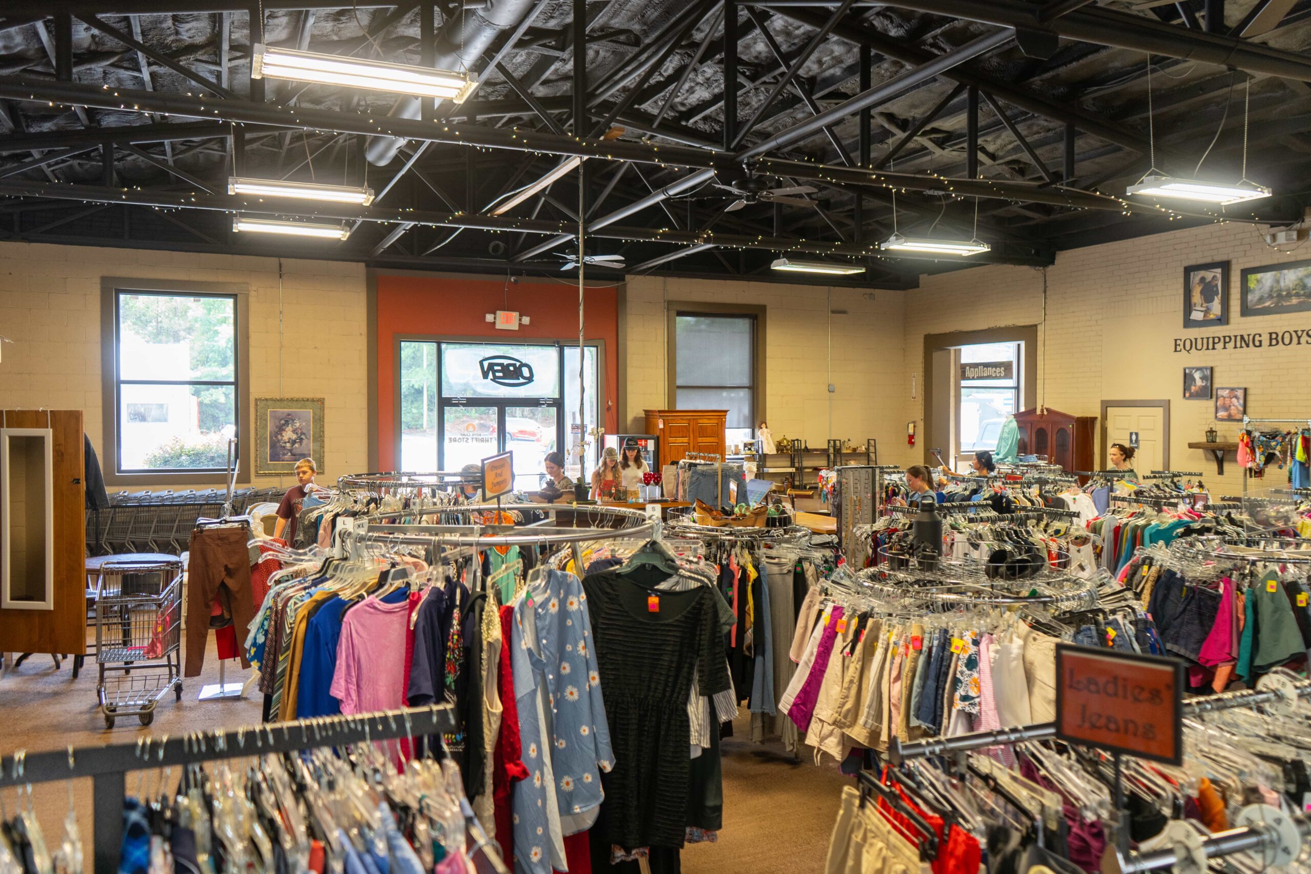 Clothing racks inside Boys Camp Thrift Store
