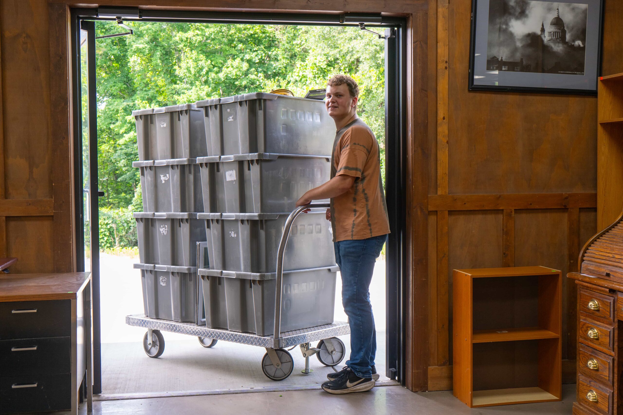 Fair Play Thrift Store team member moving donation bins