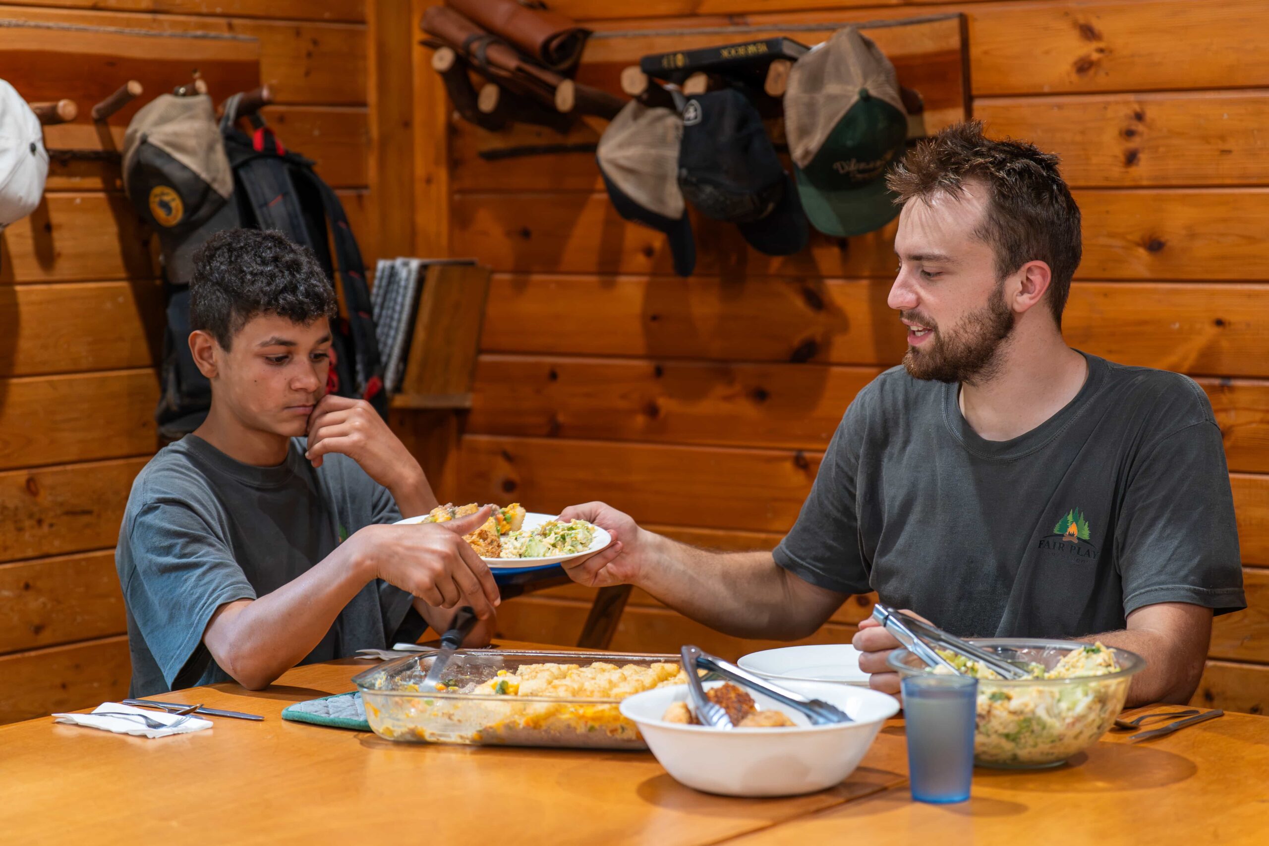 Fair Play Chief sharing a meal with a camper