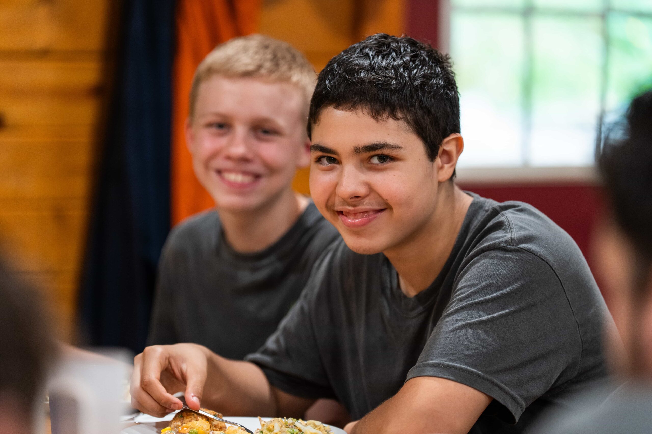 Two Fair Play Camp boys enjoying a meal together
