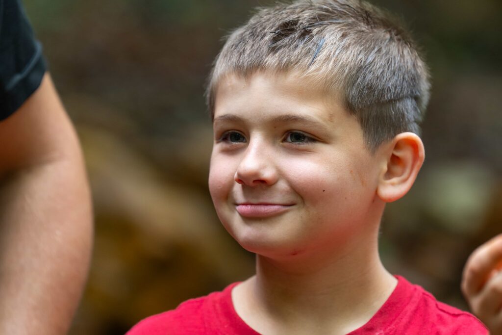 Fair Play Camp boy smiling outdoors Fair Play Camp boy smiling outdoors