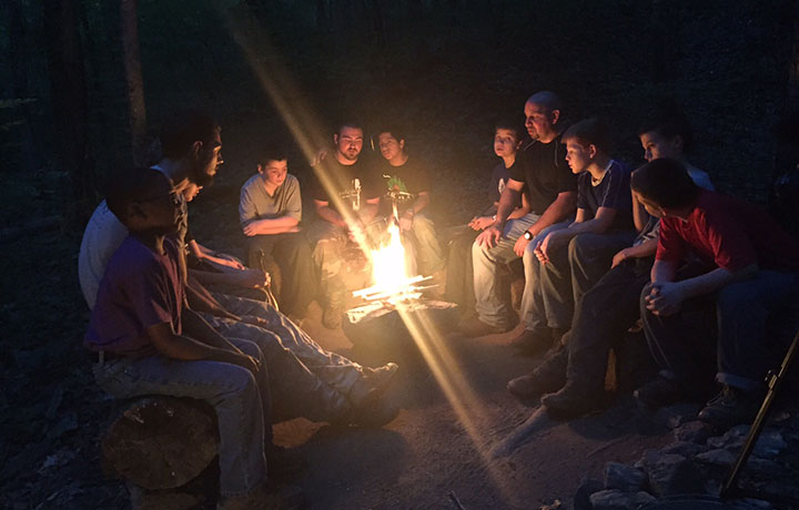 Boys around campfire